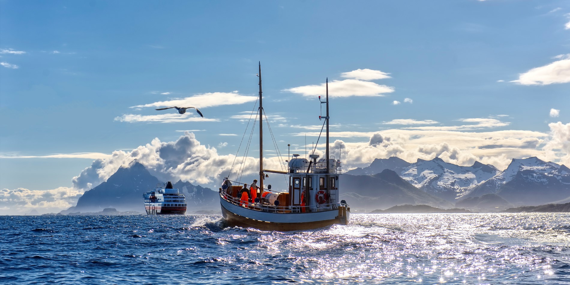 Et af Hurtigrutens skibe forsvinder ud i horisonten med en fiskerbåd bag sig 