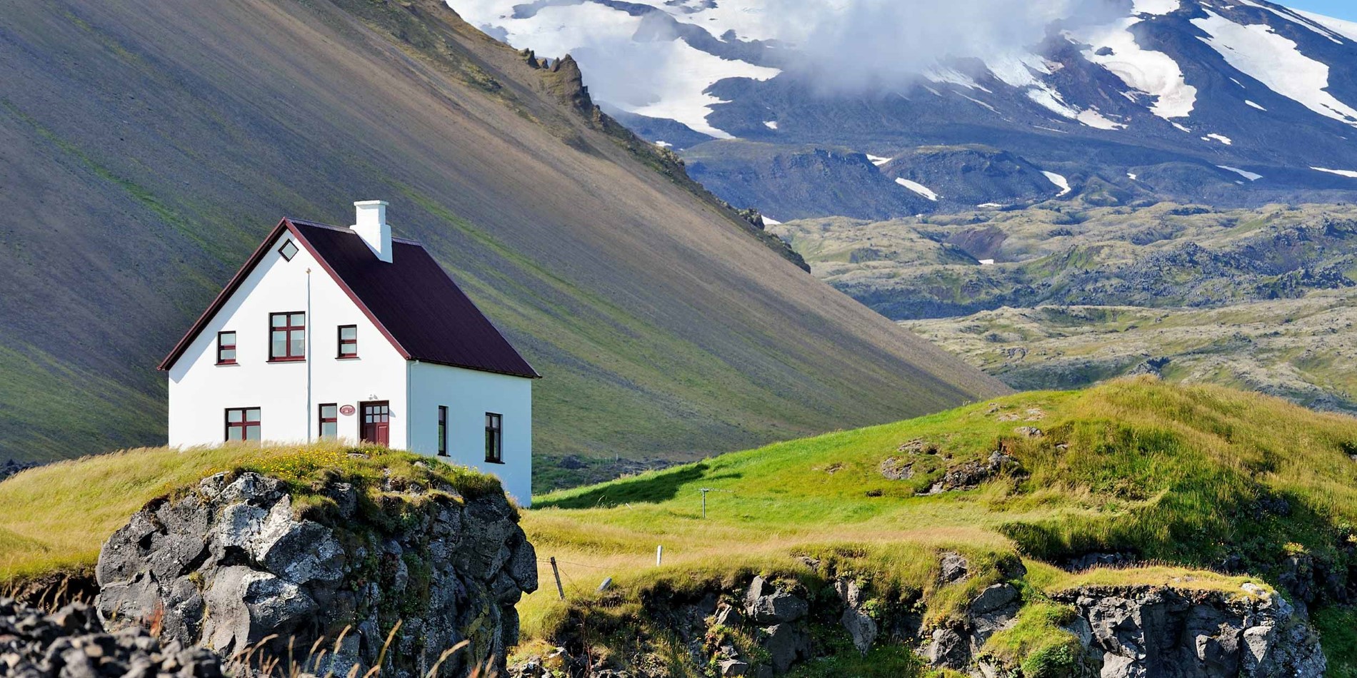 Et hus med et bjerg i baggrunden